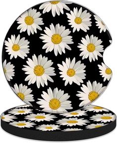 a black and white plate with daisies on it