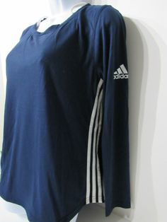 adidas ClimaLite 3-Stripe Crossover Cutout Back Long Sleeve Athletic Shirt Women's size M, L, XL in Navy, Black and Gray Features: Made from moisture-wicking, ClimaLite® fabric Tag-free scoop neckline Crossover cutout at the back ADIDAS logo printed at the left sleeve Signature three-stripe design in both sides Curved hem Semi-fitted Long sleeves Length: 24"  Fabric: 65% polyester, 35% rayon Care: Machine wash, tumble dry low heat Long Sleeve Athletic Shirt, Long Sleeve Workout Shirt, Long Sleeve Workout, Adidas Climalite, Athletic Shirts, Key Hole, Active Wear Tops, Adidas Logo, Striped Long Sleeve