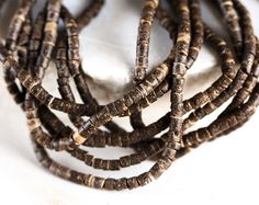 a bunch of brown beads sitting on top of a white surface