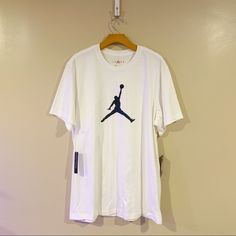 White T-Shirt Blue Jordan Emblem On The Front Design On The Lower Back Brand New White Crew Neck Graphic Tee, Nike Cotton Short Sleeve Tops, Nike White Tops For Summer, Nike Cotton Crew Neck Shirt, Nike White Short Sleeve Shirt, White Graphic Tee With Crew Neck, Nike Casual Short Sleeve T-shirt, White Crew Neck Shirt With Logo Print, Casual Nike Short Sleeve Tops