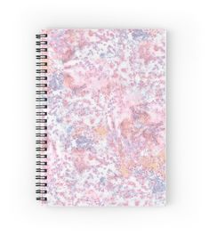 a spiral notebook with pink and yellow speckles