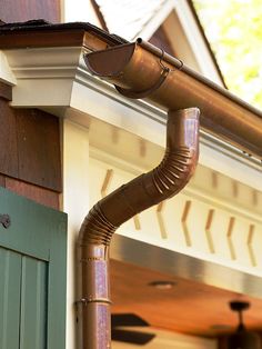 a gutter hose attached to the side of a house