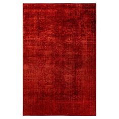 a red rug with an intricate design on the middle and bottom, it is made out of