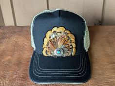 Transform your look with our Golden Trucker Hat. This versatile hat is great for music festivals, outdoor activities, and more. Channel your inner rocker and country music aficionado while staying comfortable and stylish in western fashion. It features a classic chino twill front panel and a soft tea stain mesh back panel. The antique silver Southwestern-inspired Concho with faux turquoise adds a touch of rustic charm. With a velcro closure and a comfort sweatband, it's perfect for all head sizes. Country Style Black Hat For Festival, Casual Hats For Western-themed Events, Black Country Style Hat For Festivals, Casual Cap For Western-themed Events, Casual Western-themed Cap, Black Western Hats For Festivals, Adjustable Country Hats For Outdoor, Casual Snapback Hat For Summer Country Events, Adjustable Country Style Hats For Outdoor