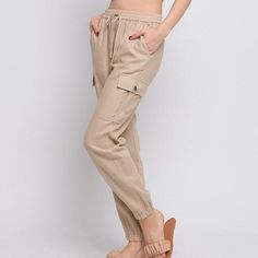 "Stay comfortable and stylish this summer with these premium quality mid rise jogger linen pants. Featuring an elastic waistband, adjustable drawstring, and cargo pockets, these pants are perfect for a beach vacation, lounge day, or resort cruise. Choose from the colors of Mint, Khaki, and White in sizes ranging from small to large. With real side pockets, you'll have a place to store your essentials while looking chic and fashionable. Upgrade your summer wardrobe with these must-have cargo linen pants Small (2/4), Medium (6/8), Large (10) Top to Bottom - 36\" Inseam -  25\" Rise - 11\" Measured on a size S Model is Wearing Size Small. Model: 5'9\"  32C bust, 25\" waist, and 36\" hips.  Color may vary slightly due to monitor resolution  55% Linen, 45% Viscose NO REFUNDS-please check sizing Casual Summer Cargo Pants With Drawstring, Summer Khaki Cargo Pants With Drawstring, Summer Relaxed Fit Cargo Pants With Drawstring, Casual Linen Cargo Bottoms, Casual Linen Cargo Pants, Summer Linen Cargo Pants With Elastic Waistband, Cotton Cargo Pants For Vacation, Summer Comfortable Relaxed Fit Cargo Pants, Summer Loungewear Cargo Pants With Elastic Waistband