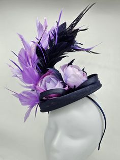 Navy blue hat accented with beautiful lavender feathers and flowers. Style to go with a variety of outfits: bridesmaids,  cocktail party,  Kentucky Derby, Rehearsal dinner, Easter and church outfits.  Ones with hair clip and headband. Are you trying to match an outfit? Send a picture and I will help you find a best hat to match your outfit.  - Rare find - Ready to ship  - Lightweight - Free Shipping - Fast shipping - Customize by adding different color flowers and or feathers Check my store for for styles and colors.  Hatsandpearls.etsy.com Find more at my website: www.hatsandpearls.com Reach out to me if you can't find what you are looking for.  I can make cake custom orders and help you style and match your outfit  Thank you for visiting! Purple Feather Headpieces For Spring, Purple Feather Mini Hat For Wedding, Purple Feathered Mini Hat For Wedding, Purple Hat For Church, Purple Party Fascinator With Handmade Flowers, Purple Fascinator With Handmade Flowers For Parties, Purple Feather Fascinator For Wedding, Purple Feathered Wedding Fascinator, Purple Handmade Flowers Fascinator For Party