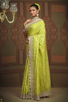 Lemon green floral jaal chanderi saree featuring intricate gota, dori, and badla work with a purple border. Accompanied by a silk chanderi padded blouse with a scalloped neckline., Fit: Relaxed Pista Green Zari Weaving Blouse Piece For Designer Wear, Designer Green Pre-draped Saree With Meenakari, Raw Silk Meenakari Saree For Reception, Reception Meenakari Raw Silk Saree, Meenakari Raw Silk Saree For Reception, Pista Green Saree With Meenakari For Eid, Pista Green Gota Work Dola Silk Saree, Pista Green Dola Silk Saree With Gota Work, Green Banarasi Silk Traditional Wear For Reception