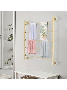 the towel rack has four towels hanging from it's sides and two hooks on each side