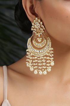 This beautifully handcrafted earrings is set in silver and copper alloy and plated with 22k gold. DETAILS Length - 7.5 cm Closure - Push Back STYLE TIP We love teaming this with classy chiffon sarees or zari silk sarees. Also looks best when worn with your royal whites, off whites and gold. We recommend styling with pastel solids or floral dresses in peachy pink, pistachio green and pastel blue too. Perfect for them Red weddings or banarasi sarees. This is a perfect solution to your pastel weddi Chandbali Earrings Gold, Kundan Chandbali, Desi Jewellery, Red Weddings, Desi Jewelry, Pastel Jewelry, Aesthetic Jewellery, Indian Wedding Jewelry Sets, Gold Jhumka Earrings