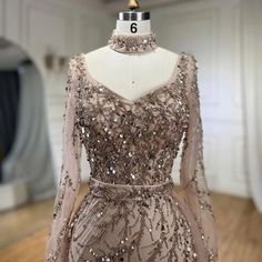 a dress on a mannequin with sequins and beads in the back