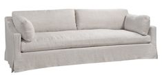 a white couch with two pillows on it