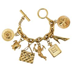 Condition : very good Made in France Material : 24K gold plated metal Color : golden Measurements : maximum wrist width 19 cm Stamp : yes Year : vintage Gold finish metal Details : Chanel charms with handbags, n°5 perfume bottles... Advantage Valois Vintage Paris : comes in its original CHANEL box Luxury Gold Bracelet With Dangling Charms, Luxury Metal Jubilee Charm Bracelet, Cheap Vintage Gold Charm Bracelet, Luxury Gold Plated Charm Bracelet Gift, Luxury Silver Vintage Charm, Luxury Classic Charm Bracelet With Polished Finish, Luxury Vintage Engraved Charm Bracelet, Luxury Heirloom Style Bracelets With Vintage Charm, Luxury Yellow Gold Chain Charm Bracelet