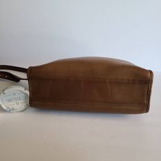 "Vtg Coach Original Swagger Bag Tan leather with brass hardware Roomy interior with inner slip pocket secured with a top zipper. 2 full size slip pockets on both sides Adjustable 44\" shoulder strap Measures: 11.5\"L, 7\"H, 4\"W Made in the United States #058-3006 Cleaned, conditioned and ready to wear! Questions? Just ask More vtg coach styles/colors also available G4" Leather Shoulder Bag With Snap Closure For Business, Leather Bucket Bag With Snap Closure In Tote Shape, Leather Tote Bucket Bag With Snap Closure, Leather Bucket Bag Tote With Snap Closure, Leather Satchel With Snap Closure And Top Handle, Business Shoulder Bag With Brass Hardware And Double Handle, Classic Bucket Shoulder Bag With Brass Hardware, Classic Tote Shoulder Bag With Snap Closure, Brown Top Handle Shoulder Bag With Snap Closure