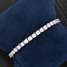 Your classic and timeless tennis bracelet with larger diamonds - perfect scale for daily wear, both day and evening! Bold enough to wear on its own, but will play nice with others as well. Super bright diamonds! 14kt white gold Will fit up to a 6.25" wrist + an addition .75" extension that can be added at buyers request Diamonds are estimated to be G/H colors & SI/I1 clarities. GIA Standards Please see qualitative report for more information. Video Below White Platinum Diamond Bracelet With Accents, Classic White Diamond Bracelet With Accents, White Platinum Diamond Jubilee Bracelet, White Diamond Cut Platinum Diamond Bracelet, White Diamond Cut Platinum Bracelet, White Platinum Jubilee Diamond Bracelet, White Platinum Diamond Cut Bracelet, Luxury White Tennis Bracelet With Prong Setting, Classic Tennis Bracelet In Diamond White With Diamond Cut