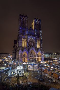 a large cathedral lit up at night with christmas lights