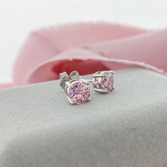 Beautiful Pink Stud Earrings. These 6mm Cubic Zirconia have the brilliance of diamonds and sparkle even more! Simple earrings that make a big impact. A romantic pink color perfect for Spring or date night.D E T A I L S 6mm Round Cubic Zirconia Butterfly Push Back Closure Sterling Silver 11mm Post 4 Prong Setting Valentine's Day Round Cut Prong Set Earrings, Dazzling Pink Round Earrings, Pink Round Diamond Earrings, Pink Brilliant Cut Earrings In Fine Jewelry Style, Pink Brilliant Cut Diamond Earrings, Pink Round Brilliant Cut Earrings, Elegant Pink Diamond Cut Earrings, Pink Brilliant Cut Round Earrings, Pink Round Earrings With Prong Setting