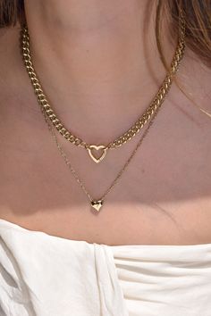 Valencia is a sleek twist on everyday elegance. With its dainty paperclip chain and petite sliding heart charm, this piece brings just the right amount of sparkle. Heart charm necklace 14k gold plated with brass base Protective coating, water resistant Chain approximately 19.5" + 2" extender Charm approximately 10mm by 5mm Heart Charm Necklace, Everyday Elegance, 14k Gold Necklace, Gold Collection, Ring Bracelet, Earring Necklace, Heart Charm, Valencia, Chains Necklace