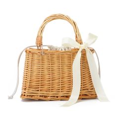 a wicker basket with a white ribbon tied around it