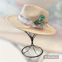 The Karmen is ready for everything spring and summer.  starting off strong with a blouse and pink floral print overlayed with elegant lace.  I pinned that down with a couple pearl hat pins on either side.  I added a small floral bouquet in the band and pink chain around the base.  Topping it off with some pink stiching at the top.  This hat is light beige and fedora style.  Head circumference is 56-58 cm and can be adjusted on the inside with a tie.  The brim measures 2.95 inches and made of 65% cotton and 35% polyester.   Each hat from The Bandit Hat Co has been customized with my own personal touch.  Each hat that has been created is unique and there will never be two the same. Flat Brim Felt Hat For Country Events In Spring, Spring Flat Brim Felt Hat For Country Events, Fitted Beige Felt Hat For Summer, Beige Fitted Felt Hat For Summer, Spring Felt Hat For Country Events With Flat Brim, Summer Beige Fitted Felt Hat, Short Brim Felt Hat For Country Events In Spring, Adjustable Short Brim Felt Hat For Spring, Spring Country Events Felt Hat With Short Brim