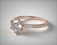 a diamond engagement ring on a white background