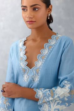 Ice blue kurta features delicate thread embroidery with cutwork details on V-shaped neckline and sleeves. Comes with a matching pant with cutwork details and a matching embroidered dupatta.
Components: 3
Pattern: Embroidered
Type Of Work: Thread Work
Neckline: Plunged V-Neck
Sleeve Type: Straight Three Quarter
Fabric: Woven Chanderi and Silk Organza
Color: Blue
Other Details: 
Wavy cutwork hem
Semi-sheer dupatta
Occasion: Puja - Aza Fashions Sheer Dupatta, Blue Kurta, Kurta Set For Women, Work Pattern, Embroidered Dupatta, Thread Embroidery, Silk Organza, Thread Work, Kurta Set