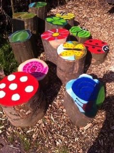 some very cute little wooden logs with ladybugs painted on them in different colors