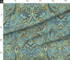 a blue and green paisley print fabric with an intricate design on the bottom half of it