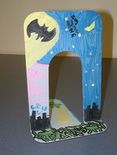 the letter h is made out of paper and decorated with bats, stars, and moon