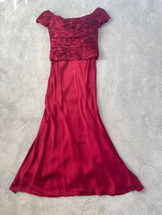 a red dress is laying on the floor