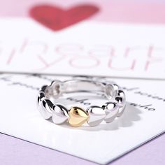 Dainty and delicate, this heart ring makes a little lovely gift for loved one or yourself. Heart is one of the most popular motifs in jewelry that often related with love.This ring sculptures a series of heart shapes. Crafted in two tone sterling silver, the only one heart featured gold tone makes it special.This band is a beautiful reminder of your timeless romance.Weight: 3.89 gWidth: 3.2 mmThickness: 1.6 mmMaterial: 925 SilverPlating Color: Silver, Yellow Gold Elegant Stackable Midi Rings For Valentine's Day, Double Heart Ring For Valentine's Day, Heart-shaped Stackable Rings As A Gift, Heart Ring For Mother's Day Promise, Heart Ring For Promise On Mother's Day, Heart-shaped Promise Ring For Mother's Day, Adjustable Heart-shaped Couple Rings For Valentine's Day, Mother's Day Heart Shaped Promise Ring, Mother's Day Promise Heart Ring