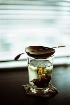 a glass cup filled with water and tea