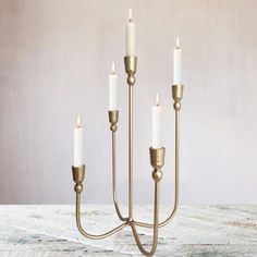 a brass candelabra with five white candles