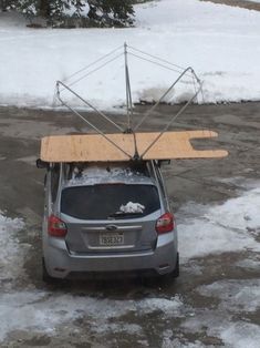 the car is parked in the parking lot with its roof open and some snow on the ground