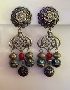 "Gorgeous eye-catching vintage Ann Cichon boho dangle earrings.    The earrings are 3 3/4\" long and 1 1/8\" wide at widest point. One is marked Ann Cichon Dallas.  The item(s) may need a good cleaning. I do not clean items, leaving that to the discretion of the buyer.  Please ask any questions before purchase as there are no returns/refunds. I am not an expert on vintage jewelry. This is from an estate. I am researching as I go.  Only ships to the lower 48 United States, excludes Hawaii and Alaska. Thank you for looking and have a great day." Vintage Festival Earrings With Dangling Beads, Vintage Dangle Chandelier Earrings For Festivals, Vintage Dangle Beaded Earrings For Festival, Vintage Pierced Drop Beaded Earrings, Handmade Vintage Drop Chandelier Earrings, Bohemian Metal Plug Earrings For Pierced Ears, Handmade Vintage Chandelier Earrings, Vintage Nickel-free Earrings For Festival, Vintage Nickel-free Drop Beaded Earrings