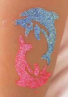 a person with glitter tattoos on their legs and the shape of a dog is painted on