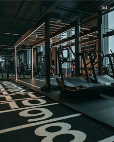 an empty gym with treadmills and exercise machines