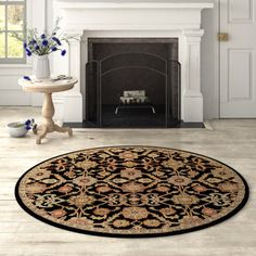 a living room with a fireplace and rug on the floor