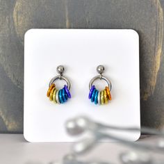 Subtly express your pride with these dainty earrings in a variety of flags.🌈 aluminum links on stainless steel ear post (intersex is gold-plate)🌈 extra ear backs included (extras are barrel/bullet style)🌈 earrings measure approx 0.5"For non-symmetrical flags (such as the rainbow flag), earrings are mirror image. If you prefer different earwire styles or metals, you can swap or upgrade earwire. Hypoallergenic Rainbow Hoop Earrings As Gift, Hypoallergenic Rainbow Round Earrings, Nickel-free Small Hoop Rainbow Earrings, Different Pride Flags, Pride Earrings, Flag Earrings, Lgbtqia Pride, Rainbow Flag, Pride Flag