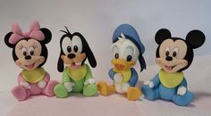 three mickey mouse figurines sitting next to each other