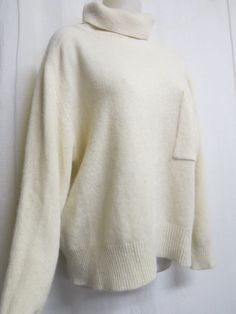 "Plush White Sweater 1990 Sarah Spencer Oversize and crazy soft! What an elegant twist on a classic white sweater! Chest pocket Lambs wool, angora and nylon blend  (NO shedding) Keep warm and make a fashion statement too! Excellent condition  all washed and ready to go Large 20\" Dropped shoulder 50\" chest. 44\"hip with stretch 19\" sleeve from under arm 26\" length Always wash in cold water and this will last a lifetime   https://www.etsy.com/shop/BelindasStyleShop" Oversized White Sweater With Pockets, White Long Sleeve Sweater With Pockets, Classic White Sweater With Pockets, Cream Sweater With Pockets For Fall, Winter Sweater With Side Pockets In Relaxed Fit, Relaxed Fit Sweater With Side Pockets For Winter, Cream Sweater With Pockets For Work, Cream Layering Sweater With Pockets, Cream Sweater With Pockets For Layering