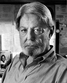 black and white photograph of an older man looking at the camera with serious expression on his face