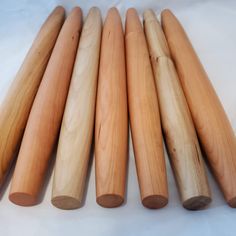 five wooden dowks lined up on a white surface