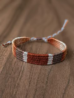 a close up of a bracelet on a wooden surface