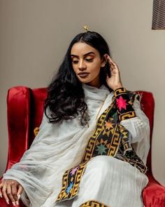 This Shimena Ethiopian traditional dress is a true masterpiece that embodies timeless elegance and sophistication. The dress is made with high-quality Menen fabric, which adds a touch of luxury and refinement to the overall design. The dress features a wide Tilf design that adds a traditional charm to the modern silhouette. The dress is designed to fit comfortably and flatteringly, with a fitted bodice and a full skirt that flows beautifully as you move. The dress is complemented by carefully se Traditional Handloom Dresses For Festivals, Traditional Cutdana Dresses For Ceremonies, Traditional Habesha Kemis For Wedding And Eid, Festive Habesha Kemis With Traditional Patterns, Traditional White Salwar Kameez With Dabka Detailing, White Salwar Kameez With Dabka For Traditional Ceremonies, White Dabka Salwar Kameez For Traditional Ceremonies, Traditional Dresses With Motifs For Transitional Season, Traditional Dress With Cutdana For Festivals