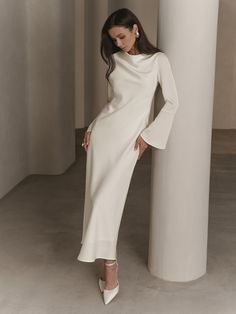 Elegant maxi dress of a semi-fitted silhouette with a delicate oval neckline long sleeves with voluminous flared cuffs and a flowing loose skirt.- maxi length- semi-fitted silhouette- oval neckline- long sleeves- flared cuffs- loose skirt- concealed side zip fastening Modest White Dress, Satin Long Sleeve Dress, Evening Wedding Guest Dresses, Elegant White Dress, Modest Evening Dress, Dinner Dress Classy, Modest Bridesmaid Dresses, Elegant Dresses Classy, White Long Sleeve Dress