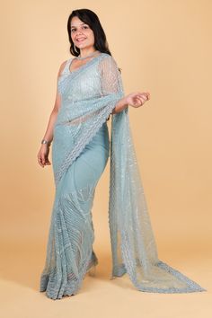 Indulge in luxurious elegance with our Net designer saree in stunning blue color. Adorned with delicate thread embroidery and sparkling sequin work, this saree exudes sophistication and exclusivity. Elevate your style and make a statement with our designer saree, perfect for any occasion. Net designer saree with thread embroidery and sequin work - blue color Saree comes with a blouse piece. Fall and pico done. Fully stitched blouse shown in pictures is optional and can be purchased seperately from our blouses and croptops section. For saree video please connect with us on whatsapp @469-937-0606 Ready to be shipped in USA from San Diego, California. All pictures are original pictures. Colors may slightly vary due to pic resolution. Blue Zari Work Pre-draped Saree For Designer Wear, Designer Unstitched Blue Saree, Blue Pre-draped Saree With Zari Work, Designer Blue Unstitched Saree, Party Wear Saree With Resham Embroidery, Elegant Dola Silk Saree With Sequins, Blue Pre-draped Saree With Unstitched Blouse For Reception, Blue Pre-draped Saree With Dupatta For Reception, Blue Semi-stitched Designer Saree