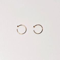 + TINY GOLD HUGGIE +TINY GOLD HUGGIE earrings made in Solid 14k Yellow Gold. Dainty open hoops with balls that hugs your ears. Shiny Yellow Gold hoops that you can wear everyday, literally. An everyday staple and heirloom. Perfect for your earlobes, cartilage or tragus. Wear 1 or a pair.+ 14ky Gold huggie hoops+ Sold as 1 single or pair + 2mm ball+ Please allow 3-5 business days to ship out. Minimalist Small Hoop Septum Ring For Everyday, Minimalist Small Hoop Ear Cuff, Tarnish Resistant, Minimalist Yellow Gold Cartilage Earrings For Everyday, Minimalist Small Hoop Ear Cuff Tarnish Resistant, Minimalist Recycled Gold Huggie Earrings, Minimalist 14k Yellow Gold Cartilage Earrings, Tiny Gold Minimalist Huggie Earrings, Minimalist Round 14k Gold Cartilage Earrings, Tiny 14k Gold Huggie Cartilage Earrings