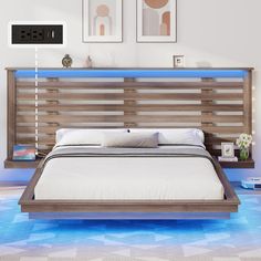 a bed with wooden headboard and white sheets in a room that has blue flooring