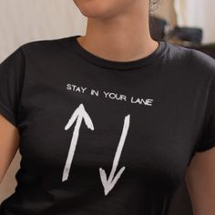 "This Stay In Your Lane T-Shirt is a perfect way to bring some humor into your day by being a little cheeky, and is a great gift for colleagues, friends and family This t-shirt is everything you've dreamed of and more. It feels soft and lightweight, with the right amount of stretch. It's comfortable and flattering for all.  * 100% combed and ring-spun cotton (Heather colors contain polyester) * Fabric weight: 4.2 oz/yd² (142 g/m²) * Pre-shrunk fabric * Side-seamed construction * Shoulder-to-shou Funny Text Print T-shirt For Everyday, Funny Graphic Print Tops For Everyday, Funny Short Sleeve T-shirt For Everyday, Funny Short Sleeve Tops For Everyday, Short Sleeve Band Merch Shirt With Funny Text, Trendy T-shirt With Funny Text For Everyday, Trendy Funny Text T-shirt For Everyday, Trendy Everyday T-shirt With Funny Text, Black Slogan Shirt For Everyday