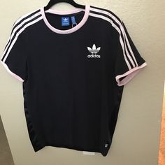 Adidas Size Medium Navy Blue With Light Pink Stripes Old School Logo Blue Tag T-Shirt 2 Materials The Back Is Sleek Front Is Jersey Knit New Without Tags ** Flawed** One Small Hole In The Seam At The Bottom Back In Photos Spring Adidas Athleisure T-shirt, Adidas Athleisure T-shirt For Spring, Blue Athleisure Tops With Three Stripes, Blue Three Stripes Tops For Summer, Adidas Blue Tops With Three Stripes, Adidas Blue Three Stripes Top, Blue Adidas Tops With Three Stripes, Adidas Blue Tops With Three Stripes Branding, Blue Adidas Tops With Three Stripes Branding